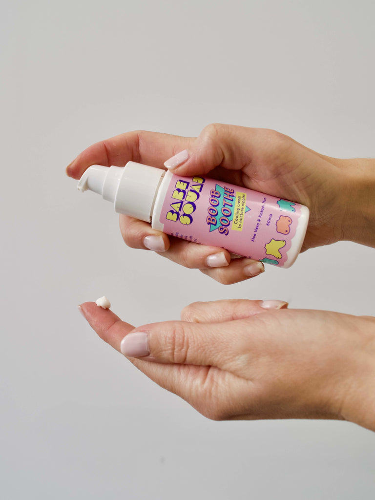 Nipple Cream shown on hands. Packaging is a pink retro style bottle 